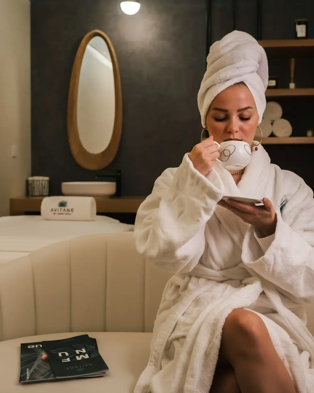 A guest relaxing in a robe in the spa lounge